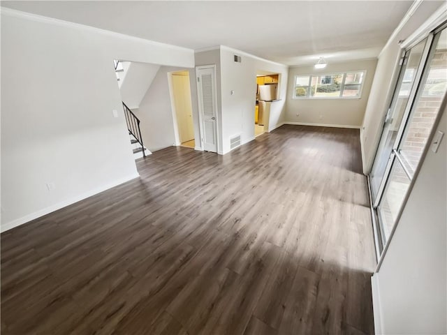 unfurnished living room featuring dark hardwood / wood-style floors and crown molding