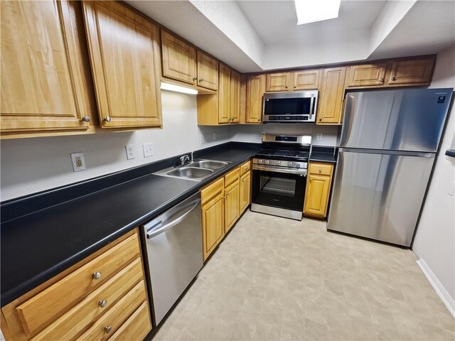 kitchen with sink and appliances with stainless steel finishes