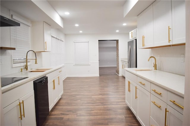 kitchen with white cabinets, dark hardwood / wood-style floors, black appliances, and sink
