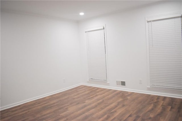 unfurnished room with dark hardwood / wood-style floors and crown molding