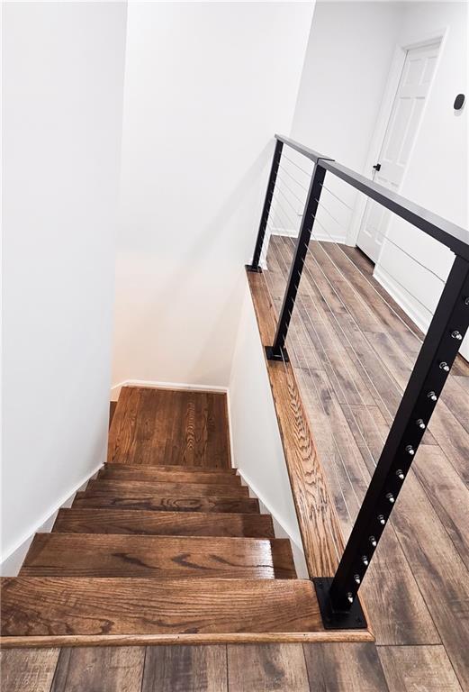 stairs featuring hardwood / wood-style flooring