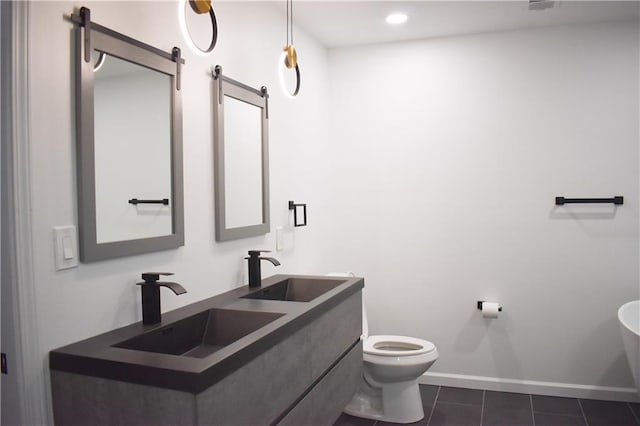 bathroom with tile patterned floors, vanity, and toilet