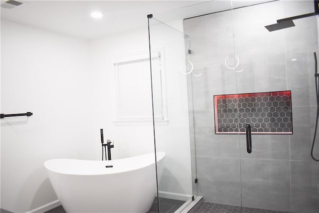 bathroom featuring independent shower and bath
