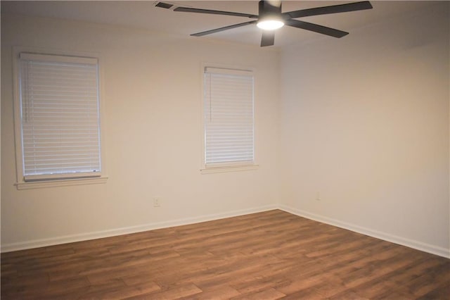 spare room featuring ceiling fan and dark hardwood / wood-style flooring