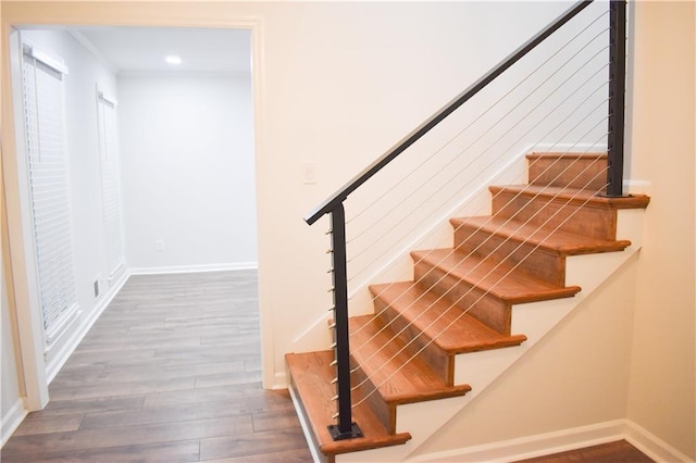 stairway with hardwood / wood-style flooring