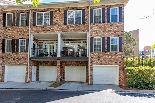 view of front of property featuring an attached garage, brick siding, and driveway