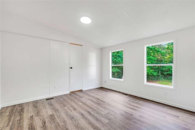 118 Buck Creek Cir, Griffin, GA 30224 - unfurnished bedroom featuring wood finished floors, vaulted ceiling, and a closet
