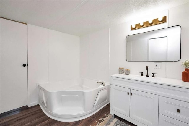 118 Buck Creek Cir, Griffin, GA 30224 - full bathroom featuring wood finished floors, vanity, a bath, and a textured ceiling