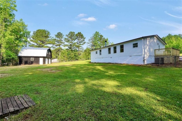118 Buck Creek Cir, Griffin, GA 30224 - view of green lawn featuring an outbuilding, a wooden deck, and a barn
