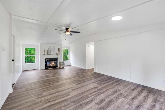 118 Buck Creek Cir, Griffin, GA 30224 - unfurnished living room featuring a ceiling fan, wood finished floors, a glass covered fireplace, and lofted ceiling