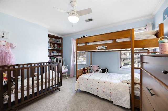 carpeted bedroom with visible vents and ornamental molding