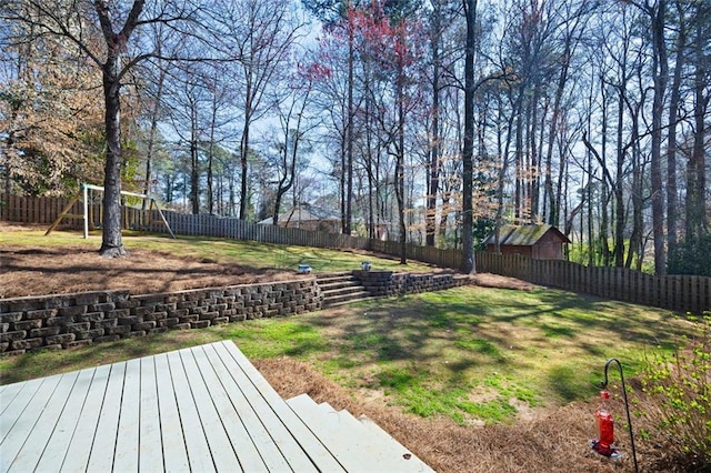 view of yard featuring a fenced backyard and a playground