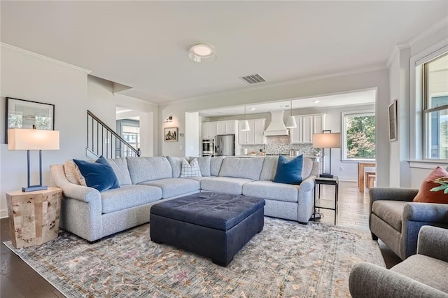 6168 Sweet Birch Ct, Acworth, GA 30101 - living area featuring wood finished floors, ornamental molding, and stairs