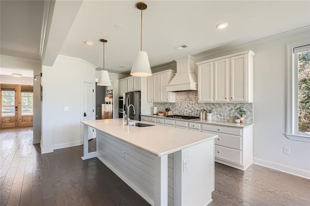 6168 Sweet Birch Ct, Acworth, GA 30101 - kitchen with premium range hood, stainless steel appliances, crown molding, a center island with sink, and dark wood-type flooring