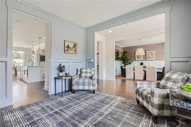 6168 Sweet Birch Ct, Acworth, GA 30101 - sitting room featuring a decorative wall, ornamental molding, wood finished floors, and wainscoting