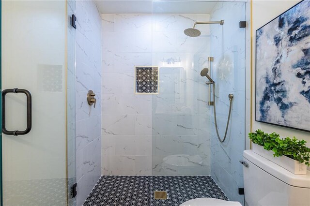 bathroom featuring toilet and walk in shower