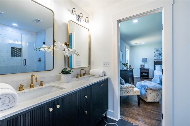 bathroom with vanity, hardwood / wood-style flooring, and a shower with shower door