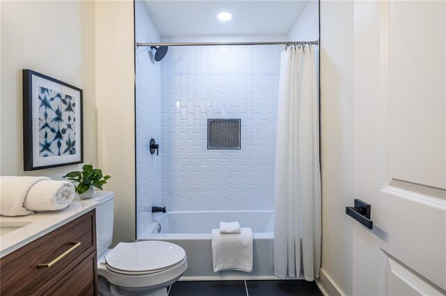 full bathroom with vanity, shower / tub combo with curtain, and toilet