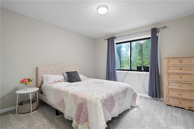 bedroom featuring carpet floors and a textured ceiling