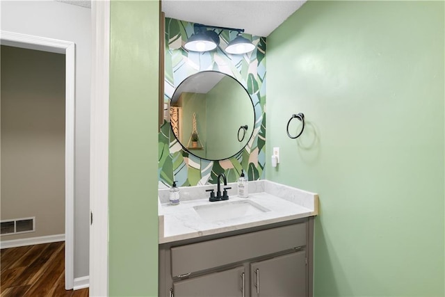 bathroom with vanity and hardwood / wood-style floors