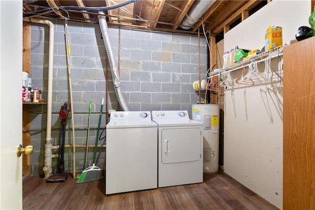 clothes washing area with washer and clothes dryer, electric water heater, and hardwood / wood-style floors