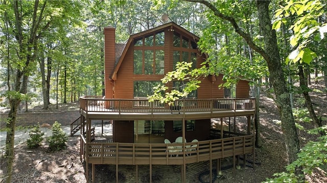 back of property featuring a wooden deck