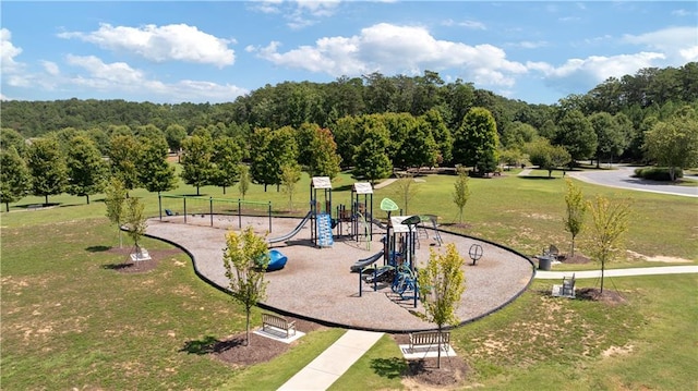 view of home's community featuring a playground and a lawn