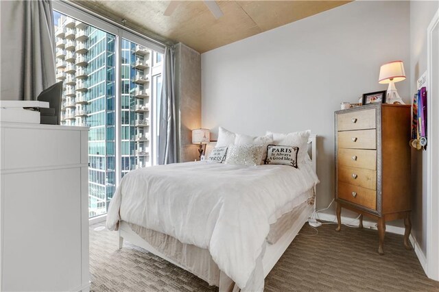 bedroom featuring multiple windows, ceiling fan, and wooden ceiling