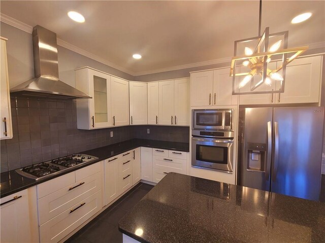 kitchen featuring wall chimney exhaust hood, ornamental molding, stainless steel dishwasher, gas stovetop, and a sink