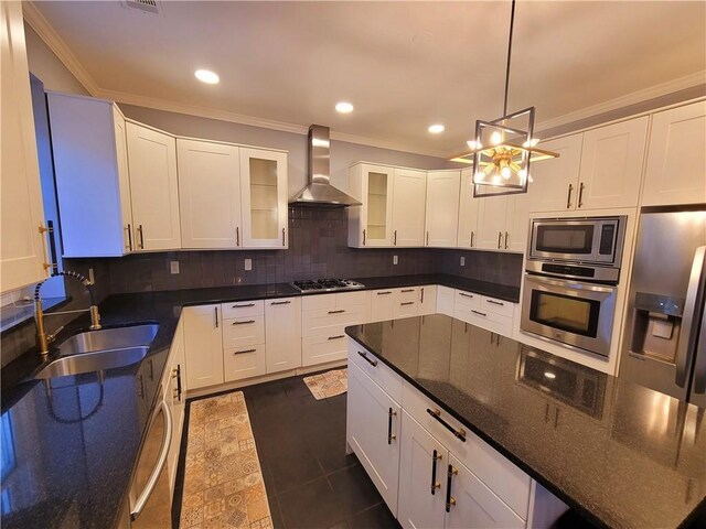 kitchen with crown molding, appliances with stainless steel finishes, a notable chandelier, and dark tile patterned flooring