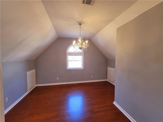 bonus room with vaulted ceiling, dark wood-style flooring, visible vents, and baseboards