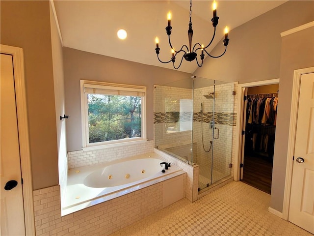 full bathroom featuring lofted ceiling, a spacious closet, a shower stall, a chandelier, and a whirlpool tub