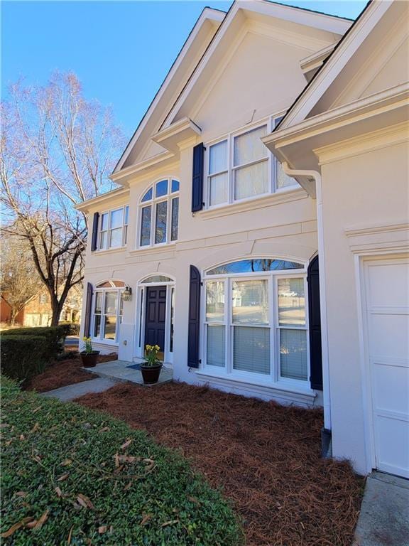 view of front of property featuring a garage and stucco siding