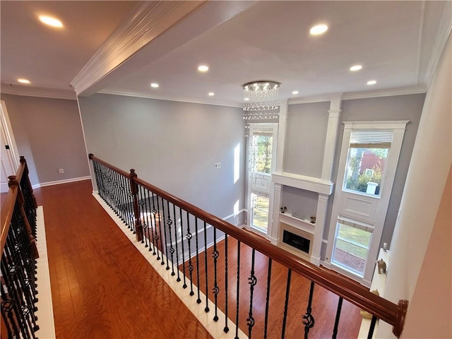 hallway with recessed lighting, crown molding, baseboards, and wood finished floors