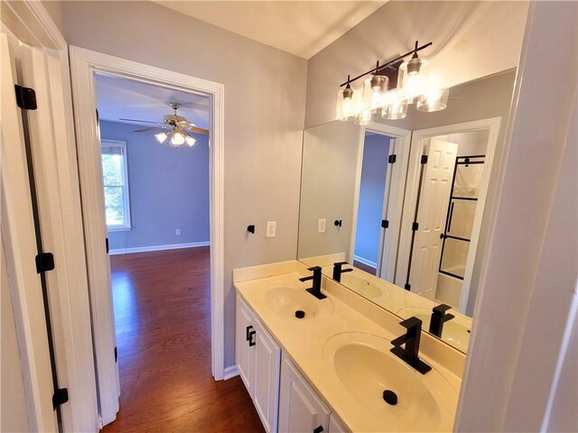 full bath with wood finished floors and a sink