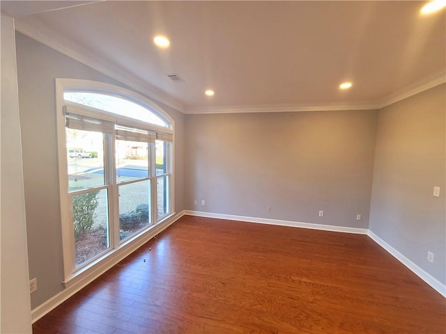 spare room featuring baseboards, dark wood finished floors, and ornamental molding