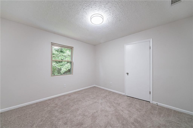 765 Martin Rd, Stone Mountain, GA 30088 - carpeted empty room with a textured ceiling and baseboards