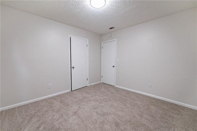 765 Martin Rd, Stone Mountain, GA 30088 - carpeted spare room with a textured ceiling and baseboards