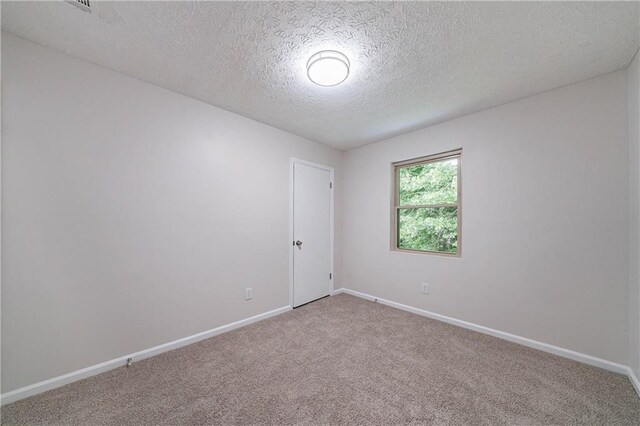 765 Martin Rd, Stone Mountain, GA 30088 - carpeted spare room with a textured ceiling and baseboards