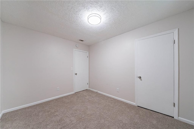 765 Martin Rd, Stone Mountain, GA 30088 - carpeted empty room with a textured ceiling and baseboards