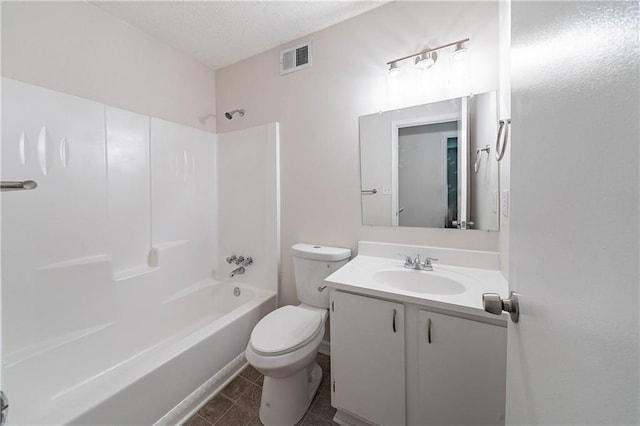765 Martin Rd, Stone Mountain, GA 30088 - bathroom featuring toilet, tub / shower combination, vanity, a textured ceiling, and tile patterned floors