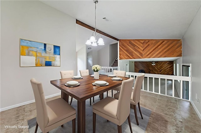 765 Martin Rd, Stone Mountain, GA 30088 - dining area featuring a chandelier, baseboards, lofted ceiling, stone finish floors, and stairway
