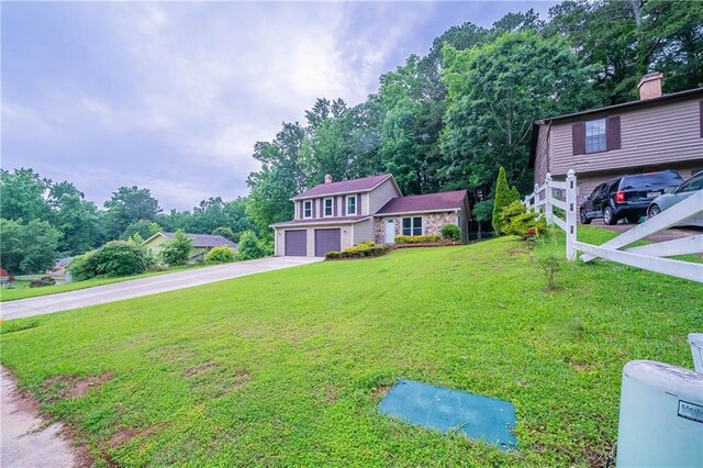 765 Martin Rd, Stone Mountain, GA 30088 - view of front of home featuring driveway, an attached garage, a chimney, and a front yard