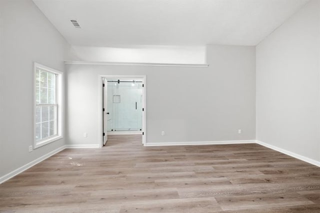 spare room with light wood-style flooring and baseboards