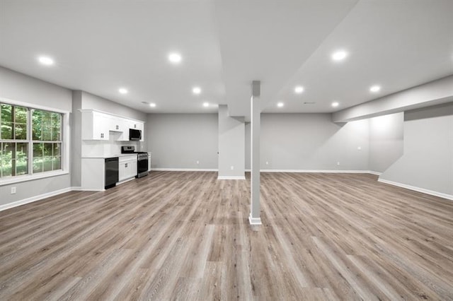 unfurnished living room with baseboards, recessed lighting, and light wood-style flooring