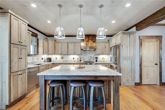 kitchen featuring pendant lighting, a kitchen island with sink, stainless steel appliances, light stone countertops, and custom exhaust hood