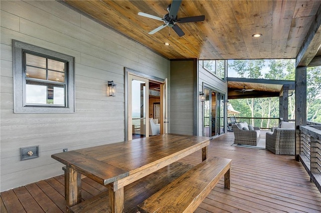 wooden terrace with ceiling fan and outdoor lounge area