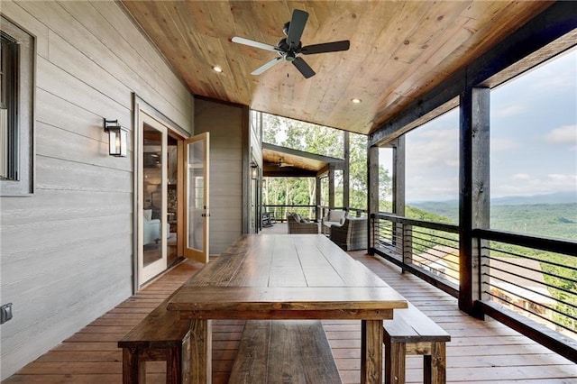 unfurnished sunroom with ceiling fan and wooden ceiling