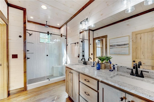 bathroom featuring wood-type flooring, a shower with door, and wood walls