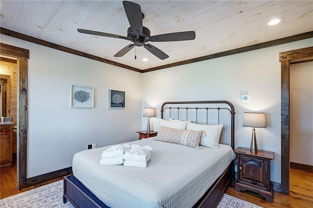 bedroom featuring hardwood / wood-style floors, crown molding, and ceiling fan